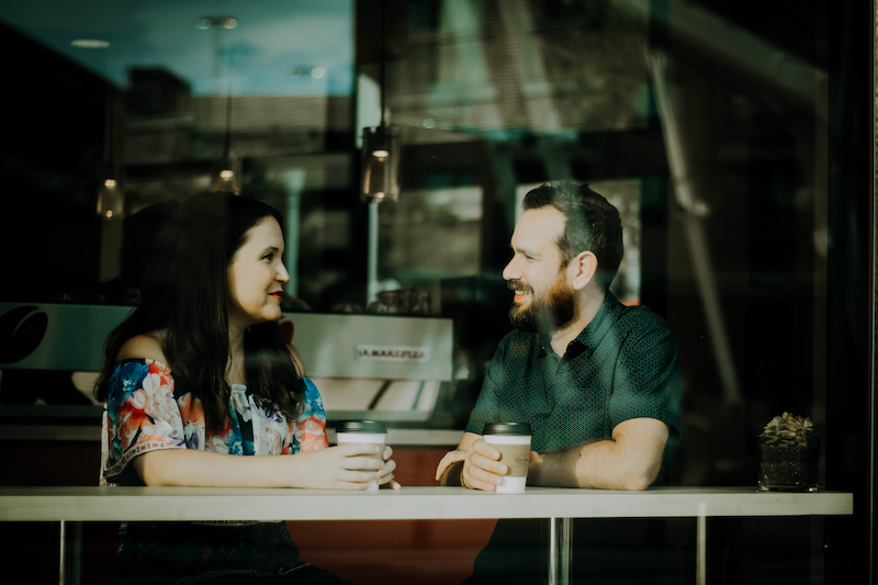 Man and woman have coffee at a cafe