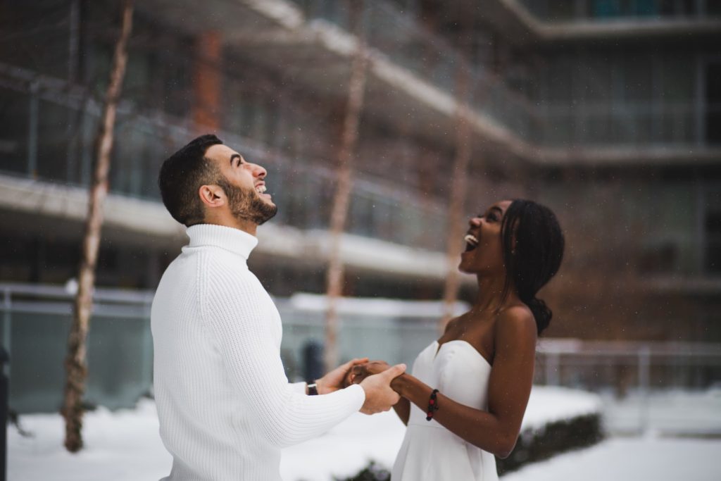 a couple looks up and laugh together