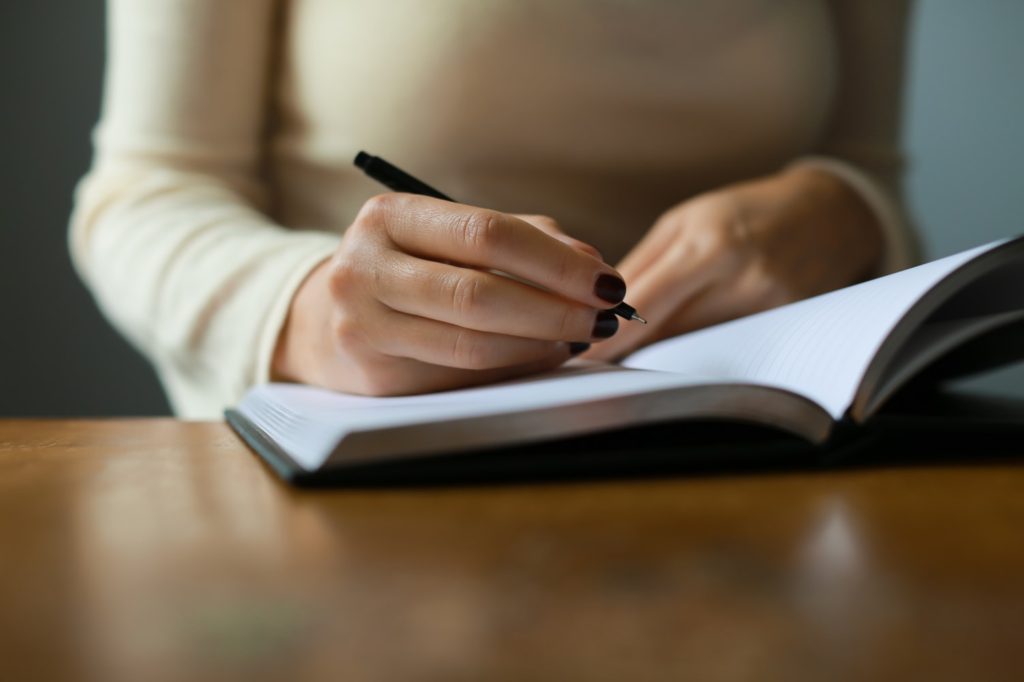 A woman writes in a journal